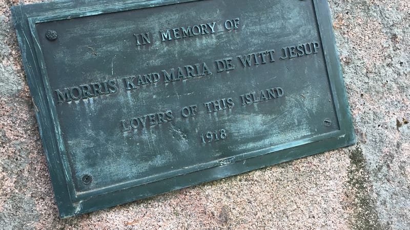 A weathered bronze memorial plaque mounted on a large granite boulder, dedicated to Morris K.